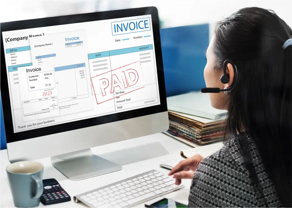 A lady working on payslips and invoice