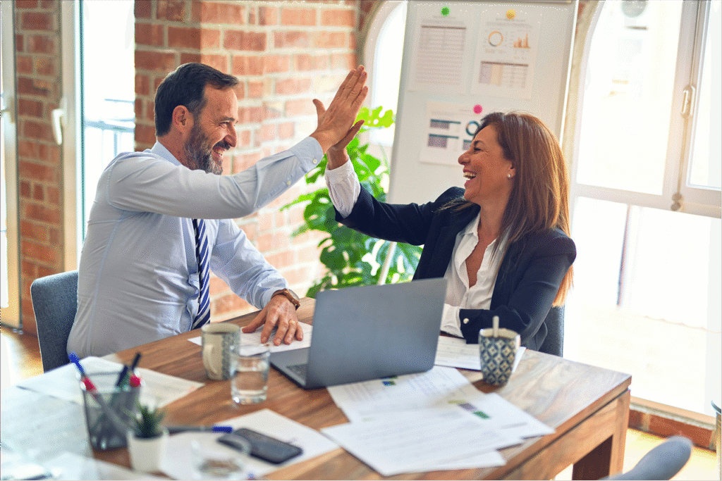 2 people cheering while doing budgeting